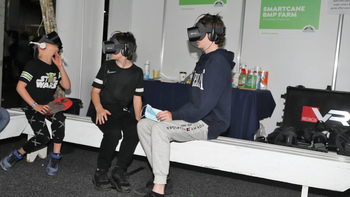 Brisbane youngsters marvelling at piles of raw sugar and high stands of cane, thanks to the virtual reality experience offered at the sugar stand. Pictures: Sally Gall