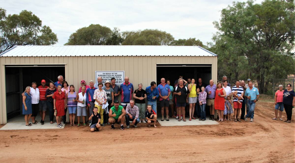 Burrumbuttock Hay Runners founder, Brendan Farrell, centre, joins Muttaburra locals celebrating the opening of the new Golf Club shed. Photos supplied by Alan McClymont.