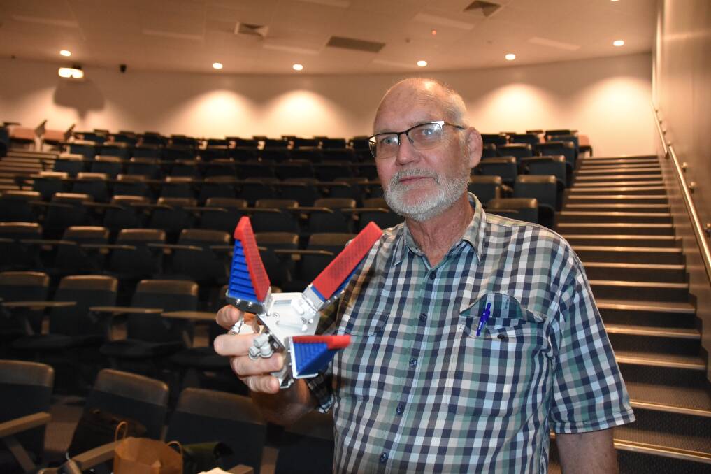 GRABBING: Central Queensland University's Kerry Walsh shows off one of the prototype mango-picking devices currently being tested. 