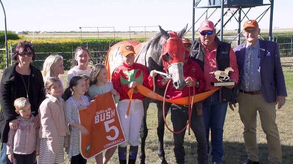 Longreach Battle of the Bush heat winner Kakakenny pictured at the trophy presentation by Longreach Race Club president Rob Luck (far right). Picture: Racing Queensland