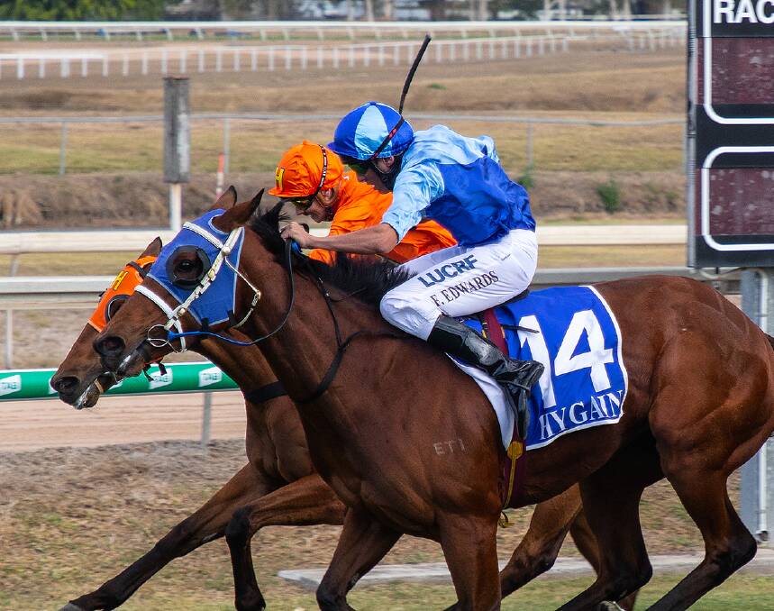 Townsville Amateurs Cup winner Sensation Ally ridden by Frank Edwards (blue colours) wins in a photo-finish from Estikhraaj ridden by Ashley Butler (orange colours). Picture: Mike Mills