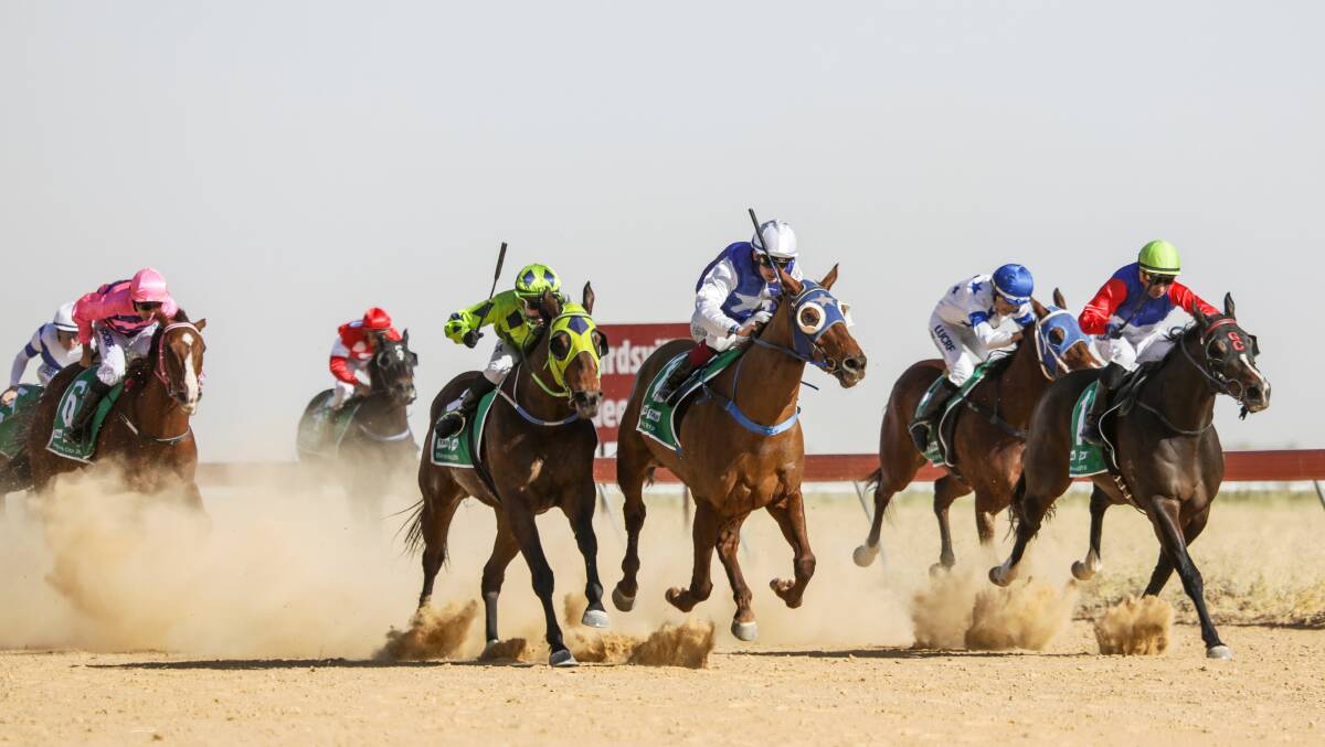 Dust flies as horses head for the finishing post at this years Birdsville Cup. The winner (second left) was French Hussler (blue colours, white star, sleeves and cap) with Eschiele (lime green, navy diamonds) second, Java (blue and white halves, red sleeves) third and Fabs Cowboy (white, dark blue stars, armbands and cap) fourth.