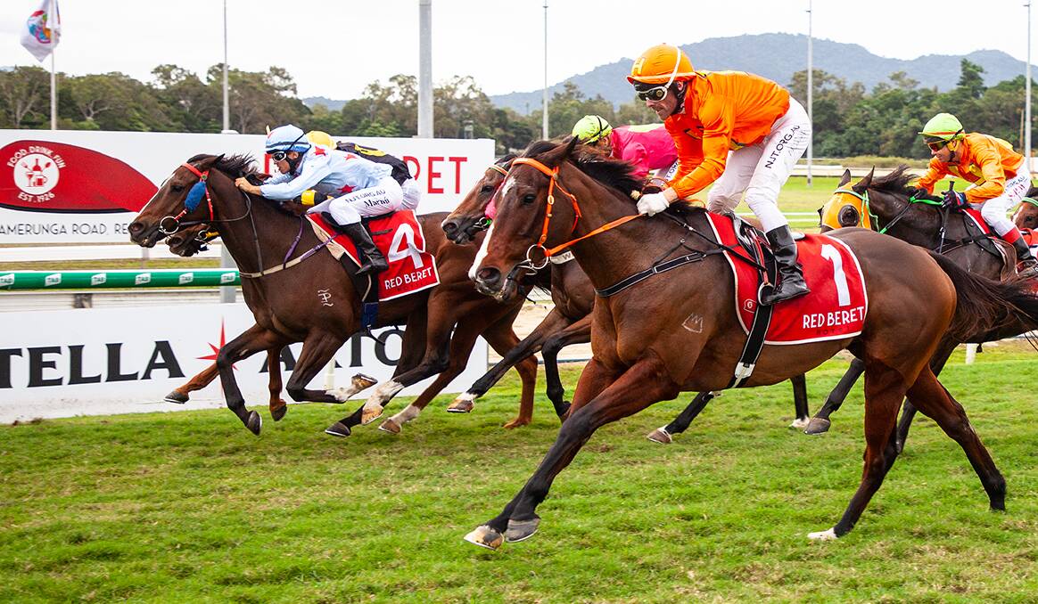 Mature aged apprentice jockey Marnu Potgieger rides Tapthetill (Blue colours, No.4 saddlecloth) to second place behind Bold Type (orange colours) at Cairns. Picture: Mike Mills
