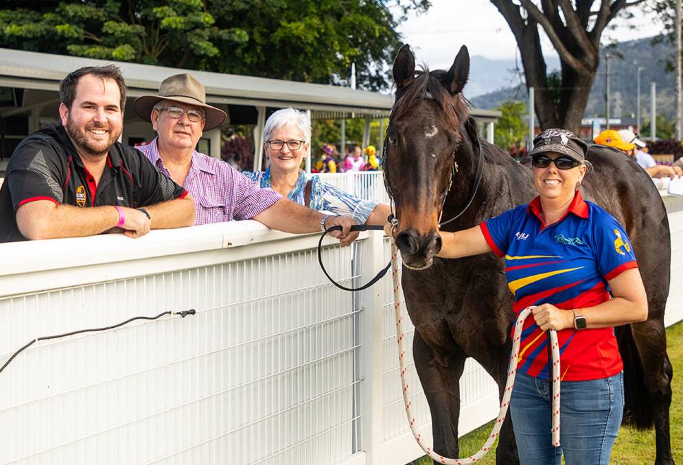 No fence sitting! Cairns trainer Trevor Rowe (centre), son and stable foreman Peter (left) and wife Helen are delighted after Desert Cowboy, held by strapper Michelle Machan, won an 950m Open handicap at Cairns on July 9. Picture: Mike Mills 