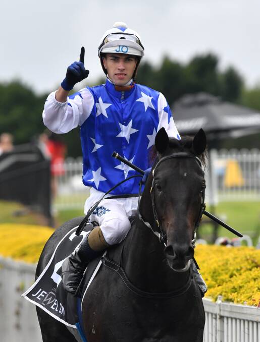 Jockey James Orman celebrates riding The Odyssey to victory at the QTIS Jewel Raceday on the Gold Coast on Saturday. (AAP Image/Darren England) 