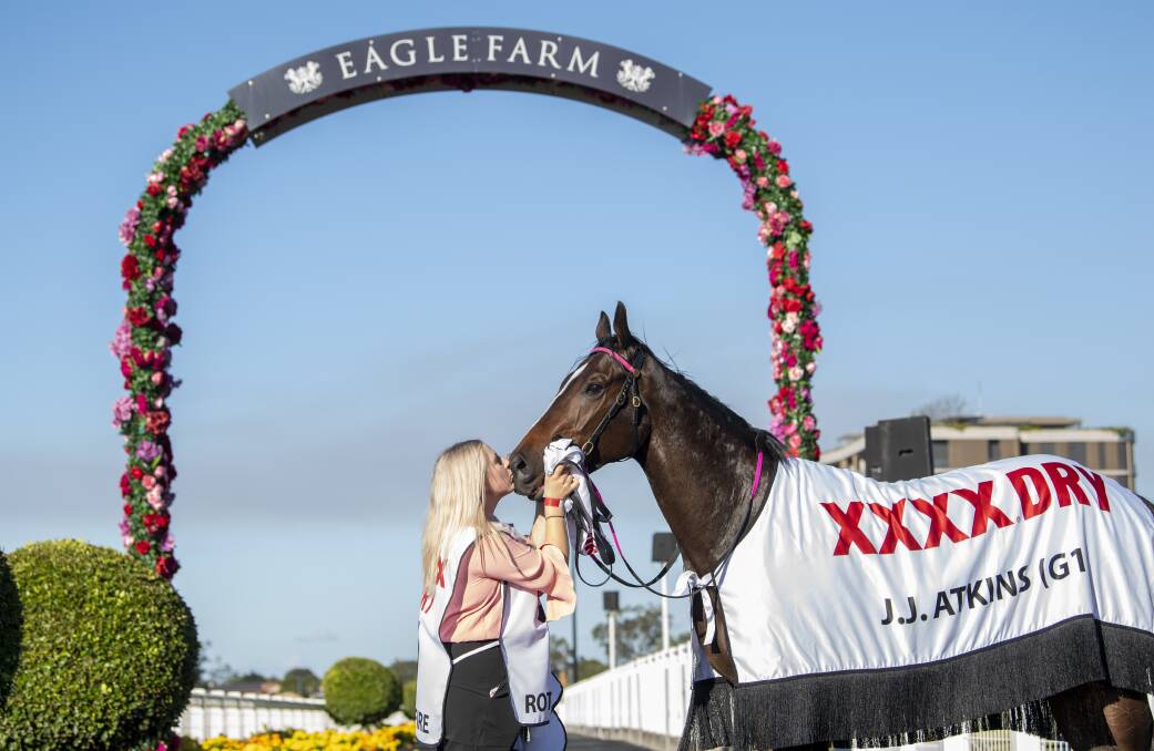 Eagle Farm Group 1 JJ Atkins winner 2YO gelding Rothfire trained by Rob Heathcote receives a kiss from his strapper and regular trackwork rider Melanie Webb. Picture: Racing Queensland