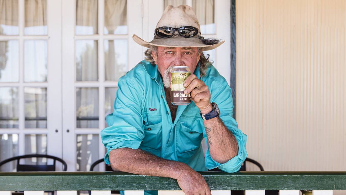 CHEERS TO OUR PIONEERS: Farmer Kevin Newton enjoying the Barcaldine Lager, that features a flock of Merino sheep and the 13 sheep shearers who made a stand against poor work conditions. Photo: Louise Gronold.