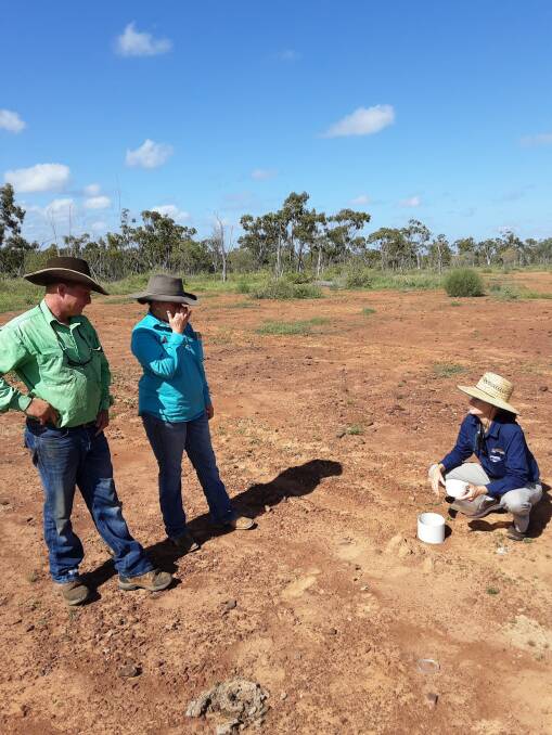NQ Dry Tropics' Bernie Claussen performs a water infiltration test on scalded land in the catchment for Pint Pot Creek with graziers Ian Collins and Stacey Kirkwood.