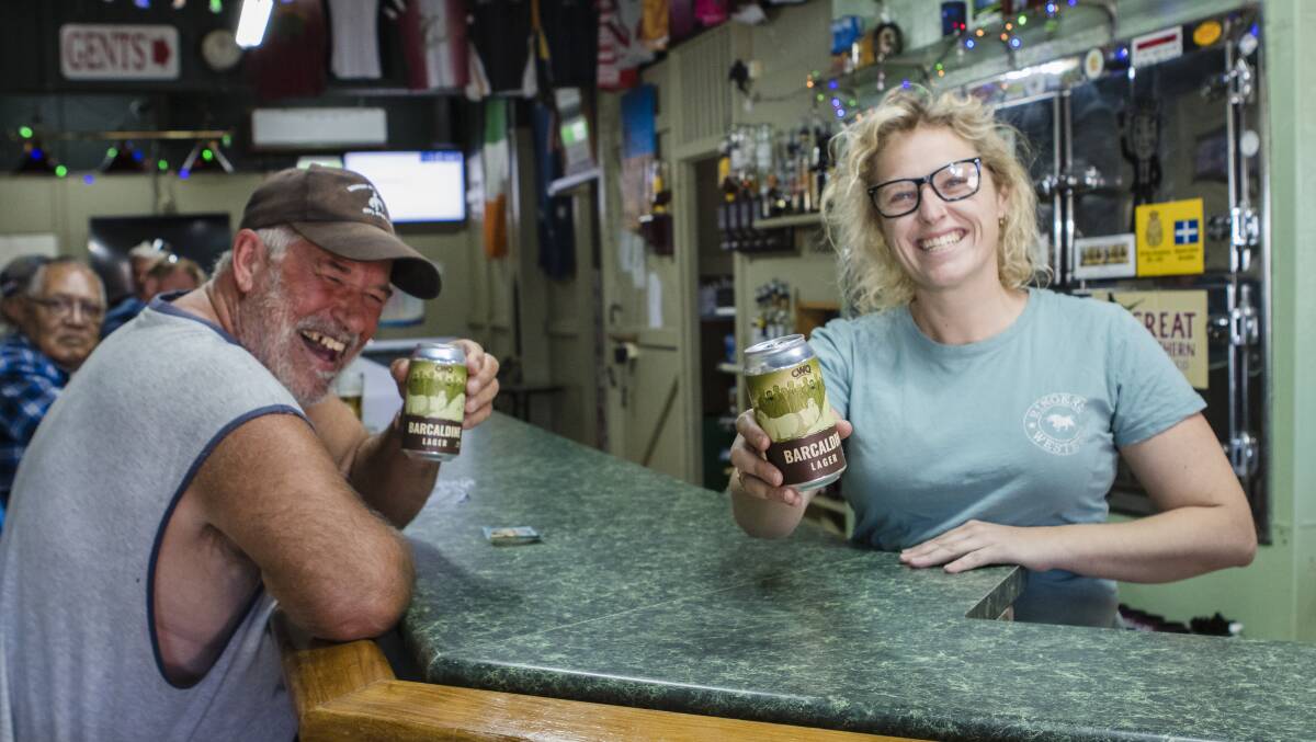 Local Trevor Boon and barmaid Elise Nicol raising a cold one. Photo: Louise Gronold.
