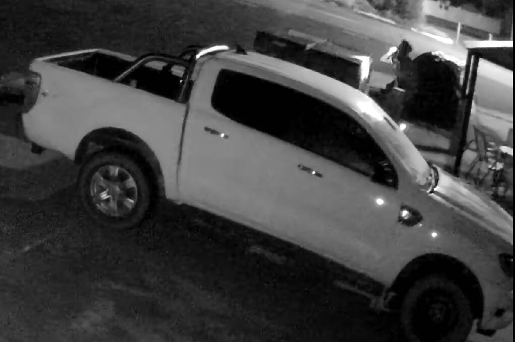 The vehicle is described as a white dual cab utility with a distinct dent on the rear drivers side tray. 