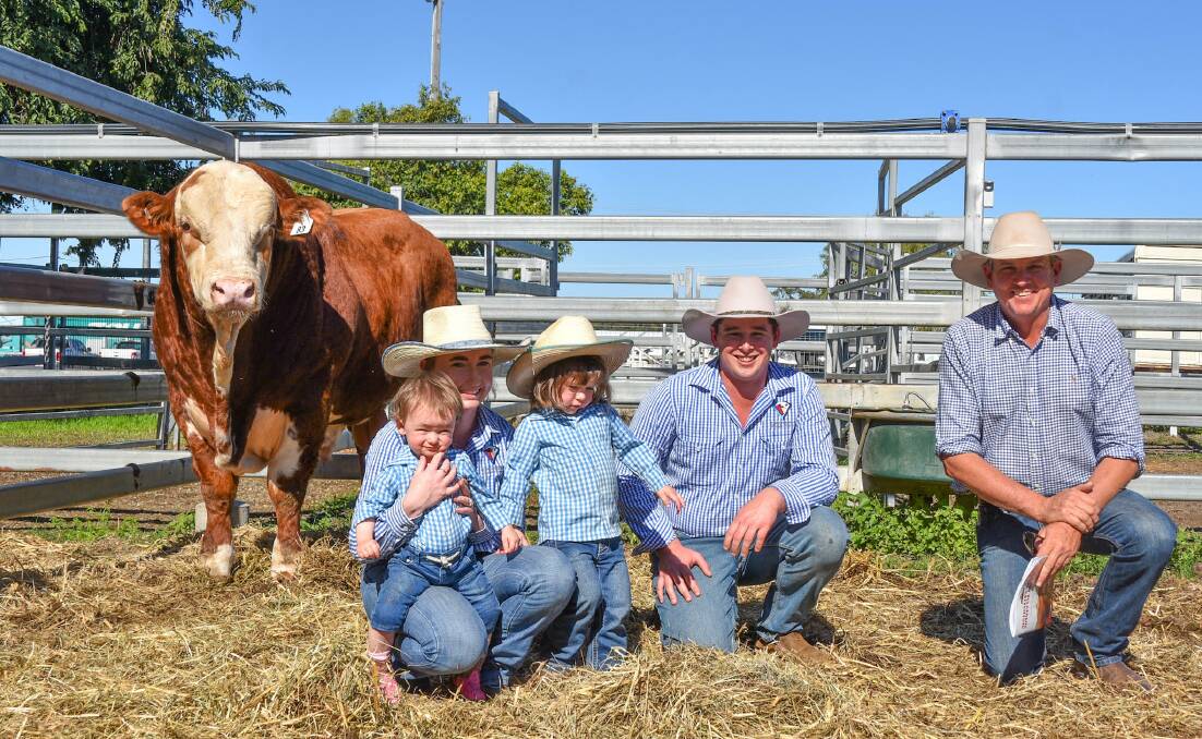 Top price bull, Glenanna Skippy, with vendors' Maddie and James Hannah and family, Glenanna Simmentals, Dubbo, NSW, with buyer Joe Streeter, Fairy Springs, Taroom. Picture by Ben Harden 