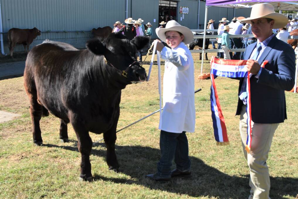 Grand Champion Led Steer: A black Limousin/Angus-cross steer, Maverick, exhibited by 12-year-old George Tucker, Gracemere, with judge Wayne York, Karragarra Simmental Droughtmaster stud, Emerald. Pictures: Ben Harden 