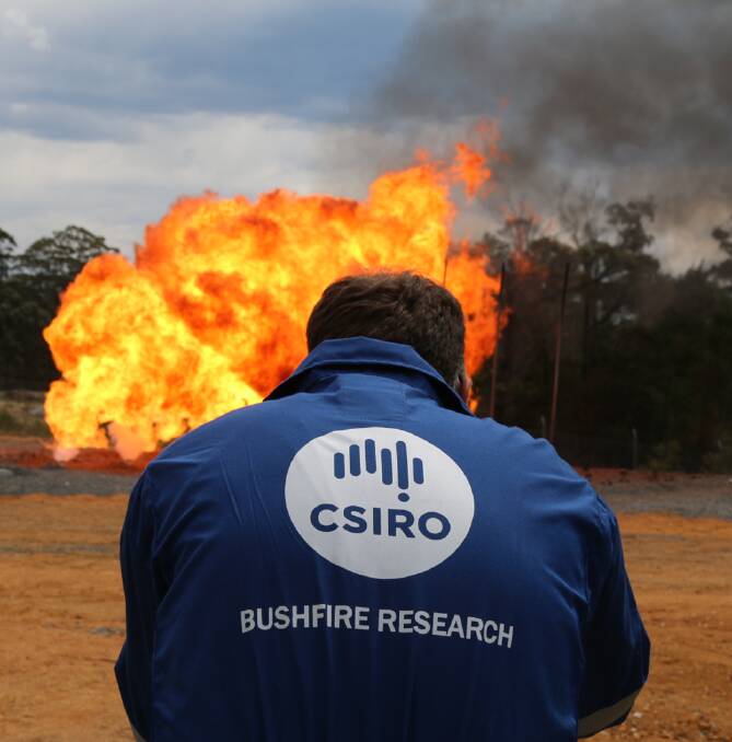 CSIRO researchers undertake bushfire testing at the Eurobodalla Rural Fire Service training facility near Mogo in NSW, the only facility in Australia with a bushfire flame front simulator that enables testing of different materials in the open under realistic bushfire conditions. Picture: CSIRO