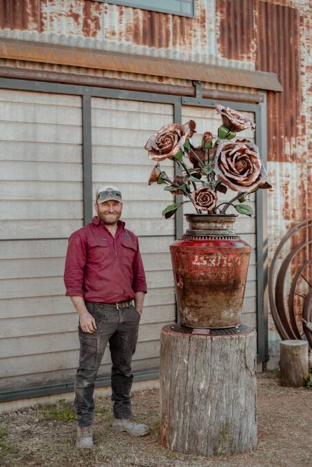A large rose sculpture made out of forged copper and mild steel. 