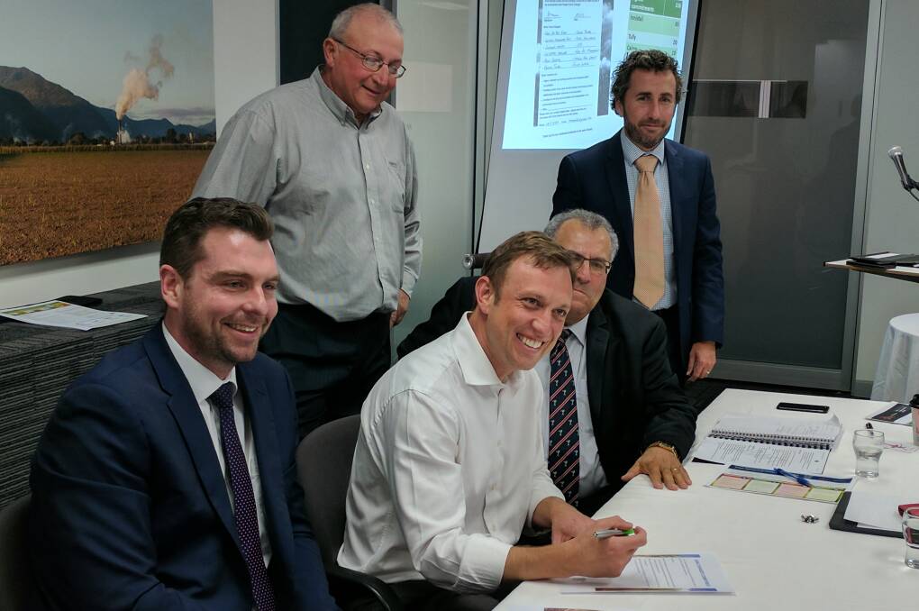 Environment Minister Steven Miles signs a Cane Changer commitment watched by (L-R) John Pickering of Behaviour Innovation, CANEGROWERS Innisfail Chairman Joe Marano, CANEGROWERS Chairman Paul Schembri and CANEGROWERS CEO Dan Galligan.