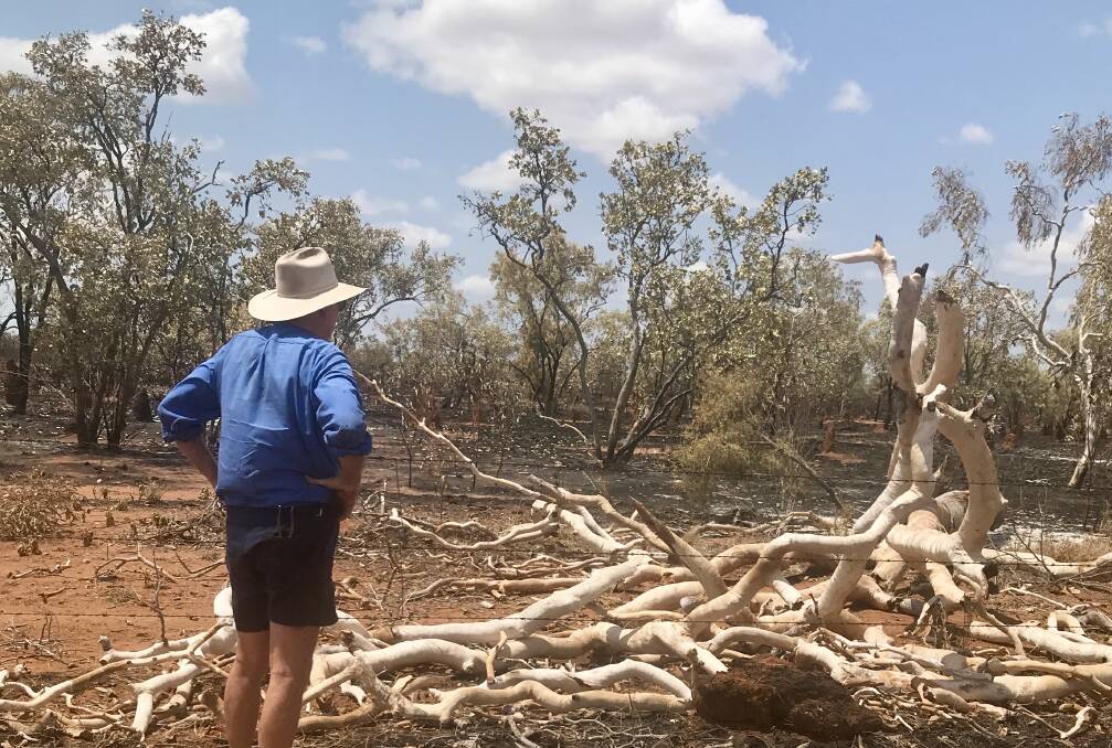 Robert Curley looks over damage caused by an electrical storm fire. Photo supplied.