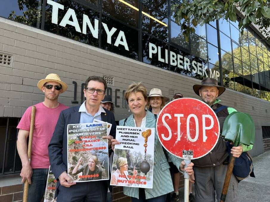 NSW politicians Joe McGirr and Helen Dalton with supporters outside Environment Minister Tanya Plibersek's office in Sydney. The 'stop' sign was given to Mrs Dalton by a roadworker who is an admirer of her stance. Picture supplied 