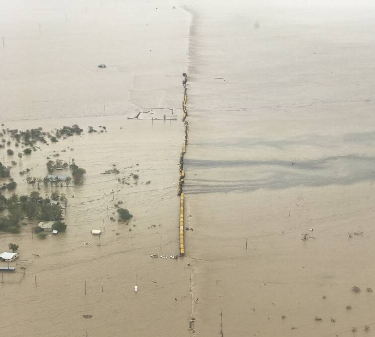 A freight train carrying zinc, lead and copper anode has derailed in floodwaters at Nelia. Supplied:QR 