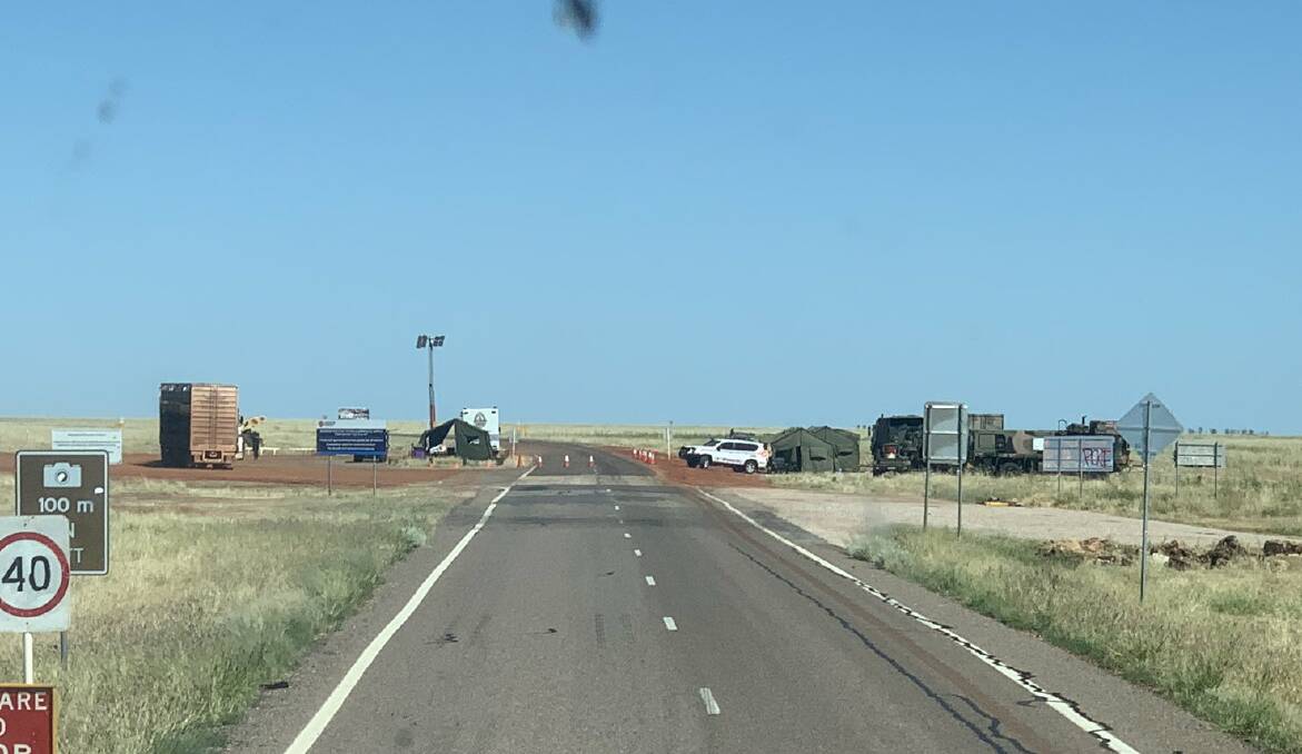 Police and army patrol the border on the Barkly Hwy at Camooweal.