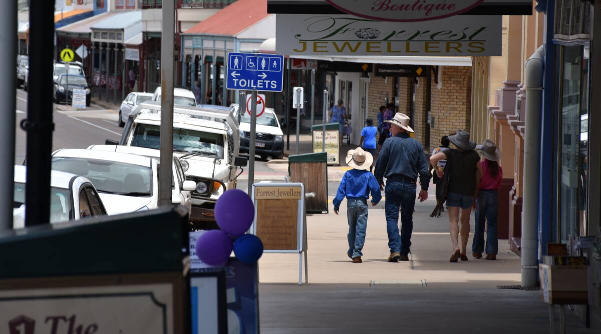 Locals walk down the main street of Charters Towers, Gill Sreet. Charters Towers is about 90 minutes south-west of Townsville. Picture: Brodie Owen