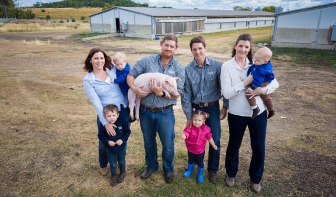 The Scheid families - Jemma with Lachlan and William, Scott holding one of their prized pigs, with Aaron, Sophia and Holly holding Tom.