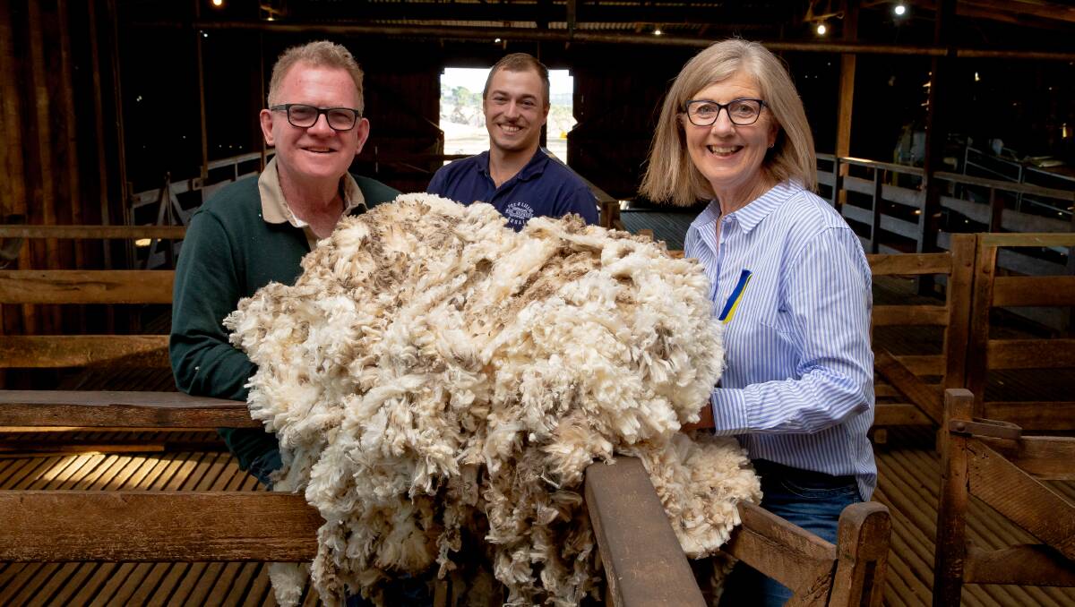 CAUSE: Brendan and Susan Finnigan, Kia Ora Merino stud, Winslow, with Kyle Smitten, Fox & Lillie Rural (middle), are donating the proceeds of their wool sale to the Ukraine humanitarian crisis. Photo by Chris Doheny.