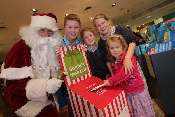 Santa with Joshua, Lucy and Alice Clark and Chelsea Wisemantel.