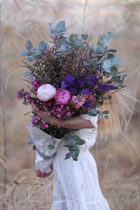 Belinda's daughter Maddy holds a lovely arrangement. Photo - Supplied.