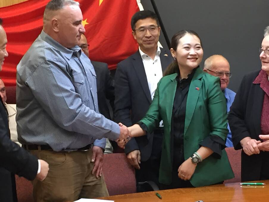 Flinders Shire CEO Daryl Buckingham congratulates Chinese partner Ms Miao Wang, representing CNVM Investment Pty Ltd.