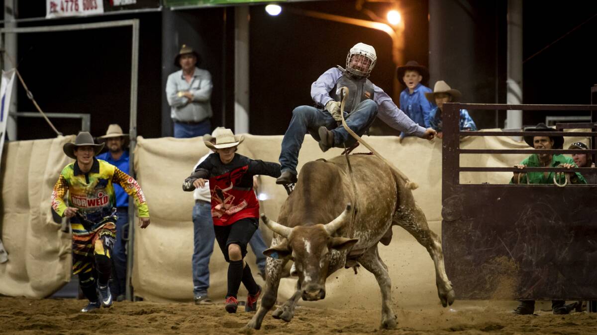 Hinchinbrook MP Nick Dametto held on for dear life as he rode a bull for charity. Photo: Mostyn Swain, Photo-Graphic-Artisan.