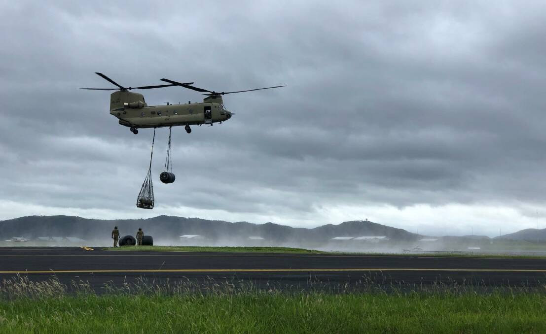 A CH-47 Chinook helicopter transports fuel as part of the Australian Defence Force's support to local communities affected by the floods in central and north Queensland.