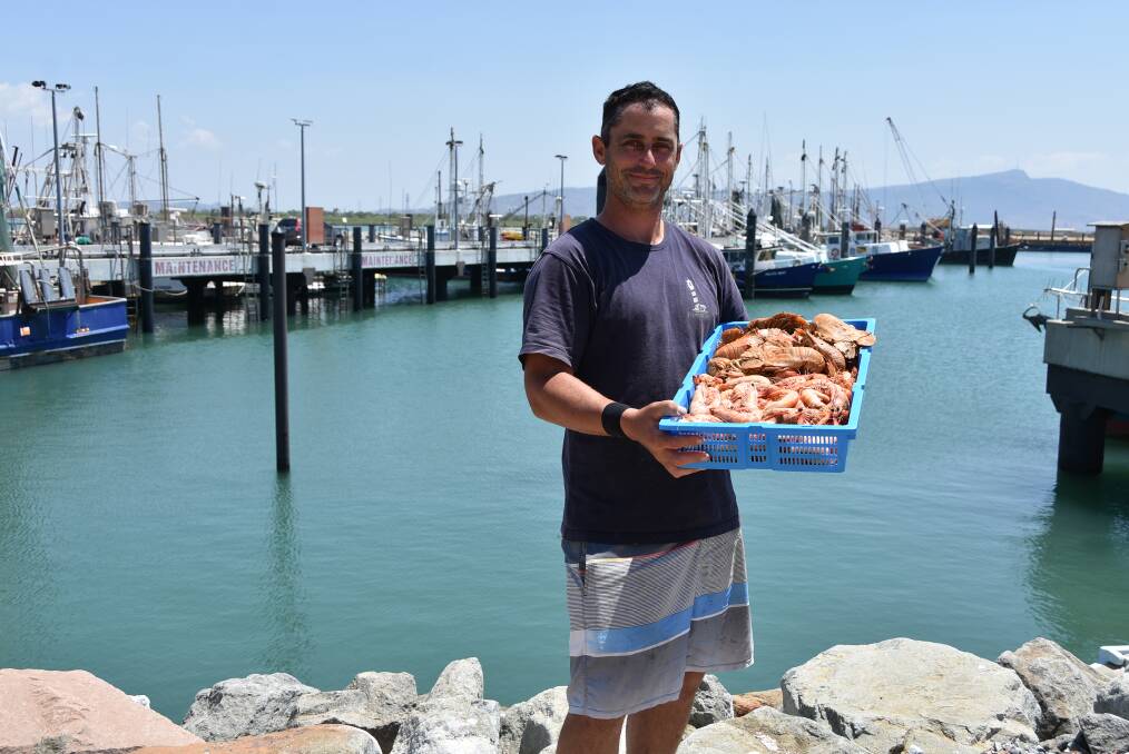 WHAT A CATCH: NQ Marina Fresh Seafood manager Lucas Dansie with bugs and prawns fresh off the trawlers in South Townsville.