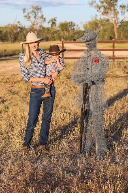 Anna and Cooper Nicholson, with her sculpture dedicated to William 'Billy' Sing, out the front of her properties Glen Elgin and Aroa Downs, 70km north-east of Clermont.