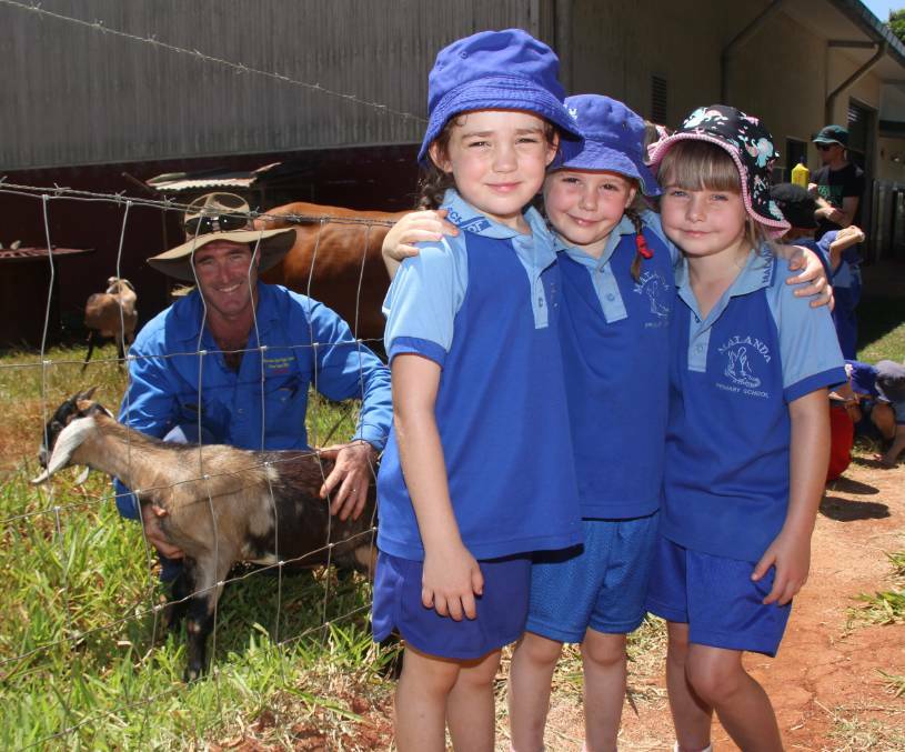 Lily Mollenhagen, Rylie Prince and Ruby Lavis, Malanda, with high school agricultural assistant Kevin Mallyon pictured at a Moo Baa Munch event in Malanda FNQ in 2016.