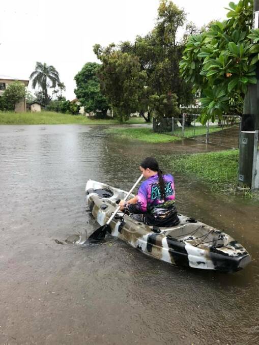 A sensible mode of transport in this weather at Valencia Street, Cranbrook, Townsville. Photo: Jaime Wiseman.