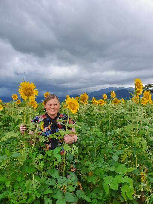 BRIGHT: Hannah OKane in her familys sunflower fallow crop near Tully. Photo: Briony Kopp.