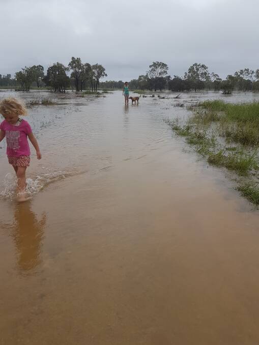 Lucy Thornhill and daughter Miranda, 2, check out the water levels at 12 Mile Station following a recent deluge. Picture: Sierra Thornhill.