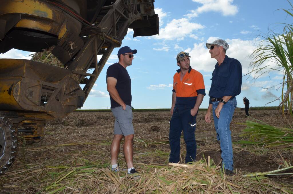 Herbert growers Sam Patane (left) and Paul Marbelli (right) discuss harvesting practices with Rocky Point grower Josh Keith (centre).