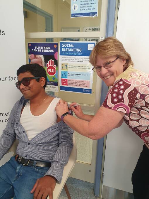 Flinders Shire Council CEO Hari Boppudi with Karen Petrie, Director of Nursing at Hughenden Multipurpose Health Service, getting a COVID vaccination. Photo: Supplied