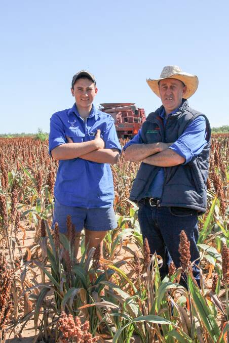 Scott Harris, right, and son Tom, pictured in 2016 in the middle of harvesting a grain sorghum crop on Strathmore Station, Georgetown. Photo: Lea Coghlan