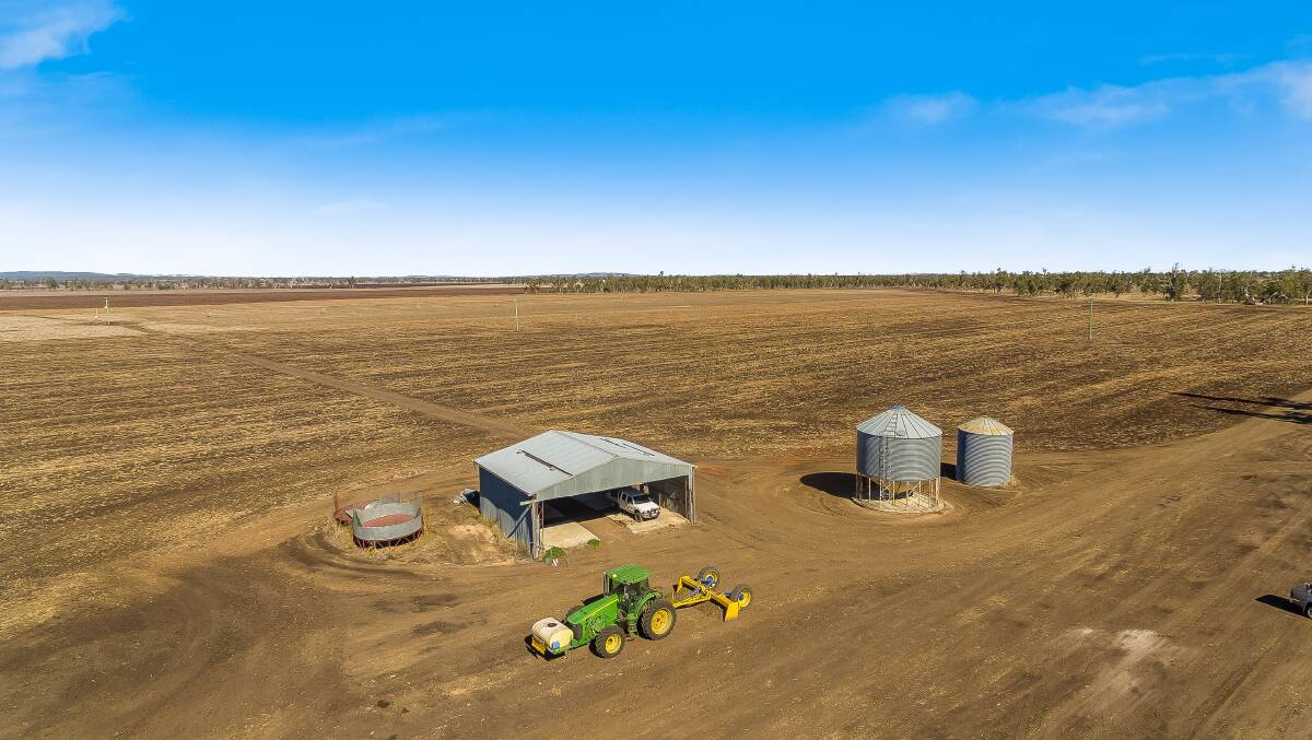 Improvements include a machinery shed and silos. 