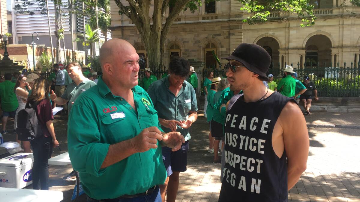 Green Shirt coordinator Martin Bella arguing the case for farmers and fishers with vegan activist Daniel outside Parliament House in Brisbane.