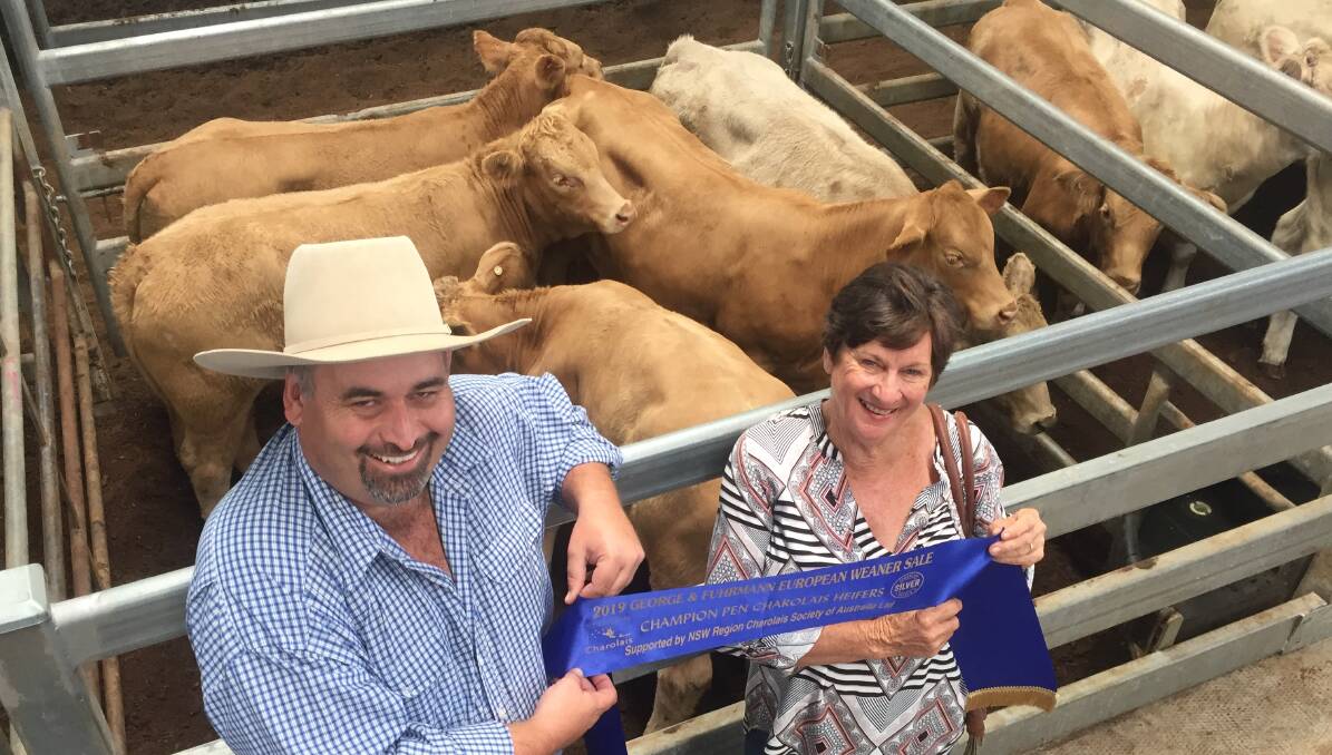 Charolais Society Of Australia president Brendan Schiewe and Deanne Hall, Homeleigh via Kyogle, with the champion pen of Euro heifers. 